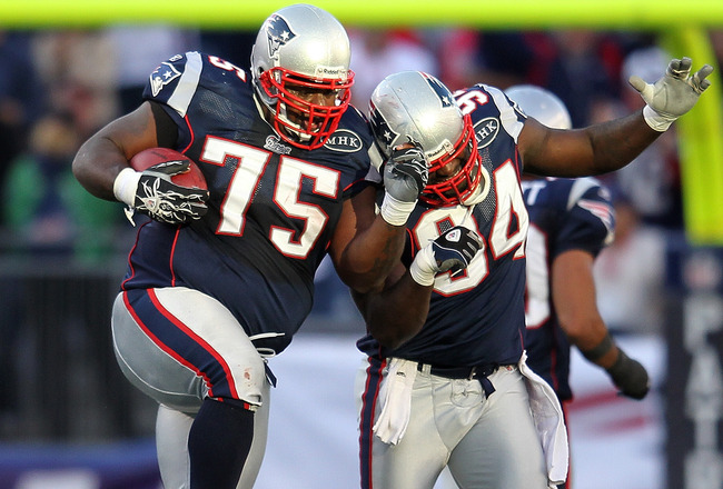 FOXBORO, MA -  SEPTEMBER 18:  Vince Wilfork #75 of the New England Patriots celebrates his interception and run with teammate Deion Branch #84 of the New England Patriots in the first half against the San Diego Chargers in the first half at Gillette Stadium on September 18, 2011 in Foxboro, Massachusetts. (Photo by Jim Rogash/Getty Images)