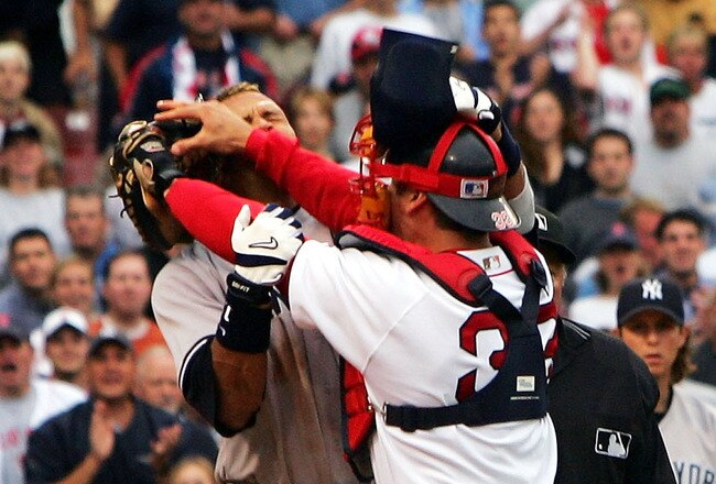 BOSTON - JULY 24:  Alex Rodriguez #13 of the New York Yankees gets into a fight with catcher Jason Varitek #33 of the Boston Red Sox after Rodriguez was hit by a pitch by pitcher Bronson Arroyo in the third inning on July 24, 2004 at Fenway Park in Boston, Massachusetts. Both Rodriguez and Varitek were ejected from the game. (Photo by Ezra Shaw/Getty Images)
