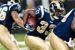 ST.LOUIS, MO - AUGUST 20: Cadillac Williams #33 of the St. Louis Rams rushes for a gain during a pre-season game against the Tennessee Titans at the Edward Jones Dome on August 20, 2011 in St.Louis, Missouri.  (Photo by Ed Szczepanski/G2etty Images)