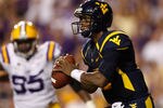 BATON ROUGE, LA - SEPTEMBER 25:  Quarterback Geno Smith #12 of the West Virginia Mountaineers looks to throw a pass against the Louisiana State University Tigers at Tiger Stadium on September 25, 2010 in Baton Rouge, Louisiana.  (Photo by Chris Graythen/Getty Images)