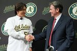OAKLAND, CA - DECEMBER 14:  Hideki Matsui (L) shakes hands with Oakland Athletics general manager Billy Beane (R) after trying on his new jersey during a press conference where he was introduced as the newest member of the Oakland Athletics at Oakland-Alameda County Coliseum on December 14, 2010 in Oakland, California.  The Oakland Athletics signed designated hitter Hideki Matsui to a one-year deal worth $4.25 million plus possible incentives for the 2011 season.  (Photo by Justin Sullivan/Getty Images)