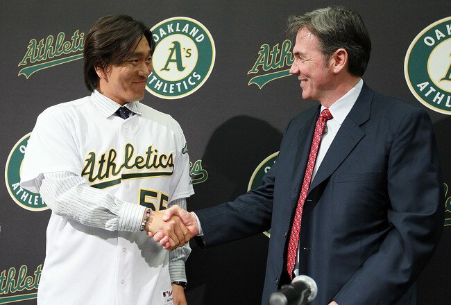OAKLAND, CA - DECEMBER 14:  Hideki Matsui (L) shakes hands with Oakland Athletics general manager Billy Beane (R) after trying on his new jersey during a press conference where he was introduced as the newest member of the Oakland Athletics at Oakland-Alameda County Coliseum on December 14, 2010 in Oakland, California.  The Oakland Athletics signed designated hitter Hideki Matsui to a one-year deal worth $4.25 million plus possible incentives for the 2011 season.  (Photo by Justin Sullivan/Getty Images)