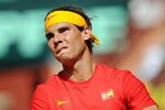 CORDOBA, SPAIN - SEPTEMBER 18:  Rafael Nadal of Spain concentrates before serving the ball to Jo-Wilfried Tsonga of France during the third and final day of the semi final Davis Cup match between Spain and France at the Plaza de Toros de los Califas on September 18, 2011 in Cordoba, Spain.  (Photo by Jasper Juinen/Getty Images)
