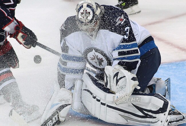 WINNIPEG, CANADA - SEPTEMBER 20: Martin St. Pierre #27 of the Columbus Blue Jackets gives Ondrej Pavelec #31 of the Winnipeg Jets a facewash at the MTS Centre on September 20, 2011 in Winnipeg, Manitoba, Canada. (Photo by Marianne Helm/Getty Images)