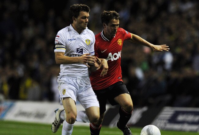 LEEDS, ENGLAND - SEPTEMBER 20:  Michael Owen (R) of Manchester United is tackled by Jonathan Howson of Leeds during the Carling Cup Third Round match between Leeds United and Manchester United at Elland Road on September 20, 2011 in Leeds, England.  (Photo by Gareth Copley/Getty Images)