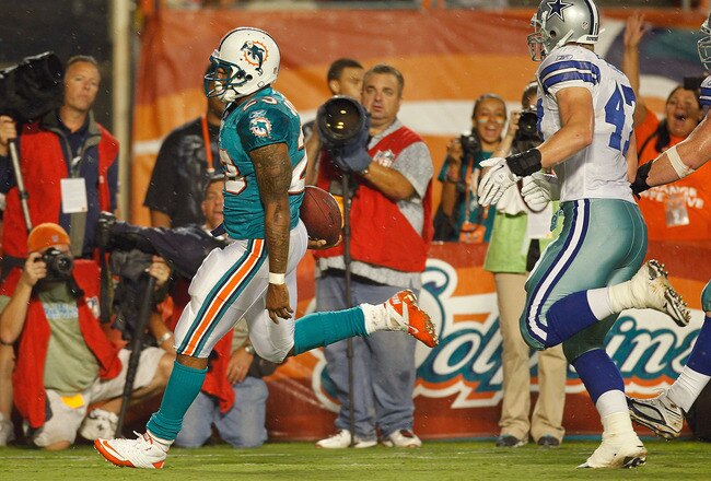 MIAMI GARDENS, FL - SEPTEMBER 01:  Larry Johnson #23 of the Miami Dolphins scores a touchdown during a Pre-Season NFL game against the Dallas Cowboys at Sun Life Stadium on September 1, 2011 in Miami Gardens, Florida.  (Photo by Mike Ehrmann/Getty Images)