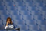 INDIANAPOLIS - NOVEMBER 04:  A fan of the Indianapolis Colts sits in the stands dejected after the Colts lost 24-20 against the New England Patriots on November 4, 2007 at the RCA Dome in Indianapolis, Indiana.  (Photo by Andy Lyons/Getty Images)