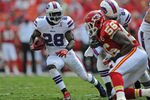 KANSAS CITY, MO - SEPTEMBER 11:  Running back C.J. Spiller #28 of the Buffalo Bills rushes to the outside against pressure from linebacker Derrick Johnson #56 of the Kansas City Chiefs during the fourth quarter on September 11, 2011 at Arrowhead Stadium in Kansas City, Missouri.  The Bills beat the Chiefs 41-7.(Photo by Peter Aiken/Getty Images)