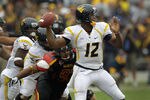 COLLEGE PARK, MD - SEPTEMBER 17: Quarterback Geno Smith #12 of the West Virginia Mountaineers thows a pass while being pressured by defensive lineman Andre Monroe #93 of the Maryland Terrapins during the second half at Byrd Stadium on September 17, 2011 in College Park, Maryland. West Virginia defeated Maryland 37-31. (Photo by Rob Carr/Getty Images)
