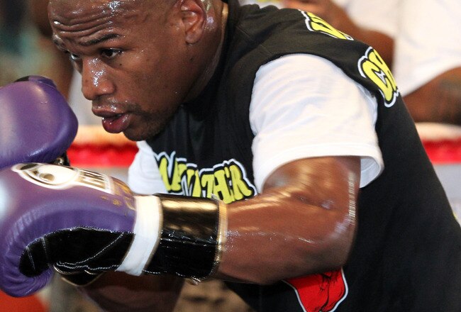 LAS VEGAS, NV - SEPTEMBER 06:  Floyd Mayweather hits the pads in the ring during his workout training session at his gym on September 6, 2011 in Las Vegas, Nevada.  (Photo by Jeff Bottari/Getty Images)