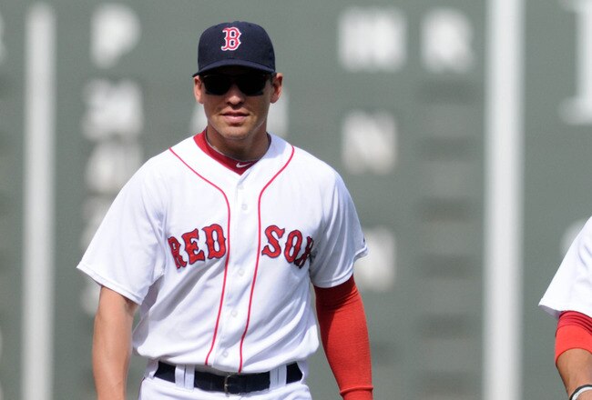 BOSTON, MA - SEPTEMBER 18:  Jacoby Ellsbury #2 (L) and Mike Aviles #3 of the Boston Red Sox warm up before the game against the Tampa Bay Rays at Fenway Park on September 18, 2011 in Boston, Massachusetts. The Rays won the game 8-5. (Photo by Darren McCollester/Getty Images)