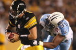 PITTSBURGH - SEPTEMBER 10:  Defensive end Jason Jones #91 tries to stop quarterback Ben Roethlisberger #7 of the Pittsburgh Steelers during the first quarter of the NFL season opener against the Tennessee Titans at Heinz Field on September 10, 2009 in Pittsburgh, Pennsylvania.(Photo by Elsa/Getty Images)