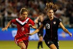PORTLAND, OR - SEPTEMBER 22:  Alex Morgan #13 of the United States dribles against Tina Romagnuolo #9 of Canada on September 22, 2011 at Jeld-Wen Field in Portland, Oregon.  (Photo by Jonathan Ferrey/Getty Images)