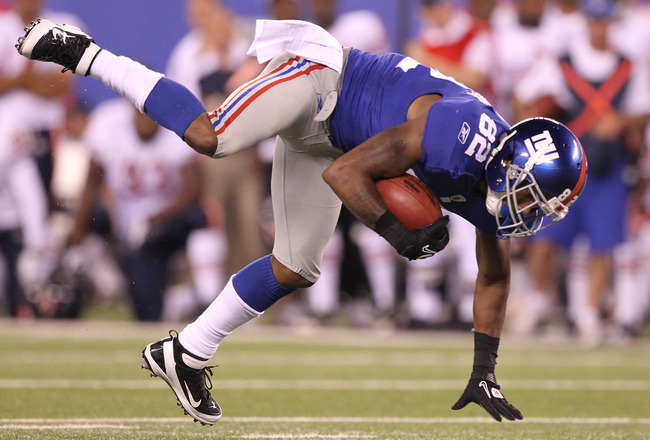 EAST RUTHERFORD, NJ - AUGUST 22:  Mario Manningham #82 of the New York Giants flies through the air after making a catch against the Chicago Bears during their pre season game on August 22, 2011 at The New Meadowlands Stadium in East Rutherford, New Jersey.  (Photo by Al Bello/Getty Images)