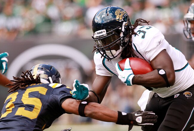 EAST RUTHERFORD, NJ - SEPTEMBER 18: Isaiah Trufant #35 of the New York Jets tackles Deji Karim #35 of the Jacksonville Jaguars at MetLife Stadium Stadium on September 18, 2011 in East Rutherford, New Jersey.  (Photo by Nick Laham/Getty Images)