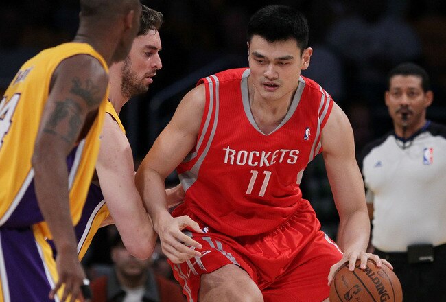LOS ANGELES, CA - OCTOBER 26:  Pau Gasol #16 of the Los Angeles Lakers defends as Yao Ming #11 of the Houston Rockets controls the ball during their NBA game at Staples Center on October 26, 2010 in Los Angeles, California. NOTE TO USER: User expressly acknowledges and agrees that, by downloading and or using this photograph, User is consenting to the terms and conditions of the Getty Images License Agreement.  (Photo by Jeff Gross/Getty Images)