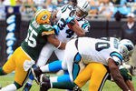 CHARLOTTE, NC - SEPTEMBER 18:   Desmond Bishop #55 of the Green Bay Packers tackles  DeAngelo Williams #34 of the Carolina Panthers during their game at Bank of America Stadium on September 18, 2011 in Charlotte, North Carolina.  (Photo by Streeter Lecka/Getty Images)