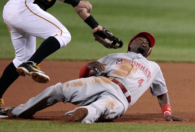 PITTSBURGH, PA - SEPTEMBER 23:  Brandon Phillips #4 of the Cincinnati Reds avoids a tag by Fagabeefe#5 of the Pittsburgh Pirates during the game on September 23, 2011 at PNC Park in Pittsburgh, Pennsylvania.  (Photo by Jared Wickerham/Getty Images)