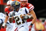 LINCOLN, NE - SEPTEMBER 03: Marquis Green #21 of the Chattanooga Mocs tries to avoid the Nebraska Cornhusker defense during their game at Memorial Stadium September 3, 2011in Lincoln, Nebraska. Nebraska won 40-7. (Photo by Eric Francis/Getty Images)