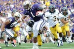 SEATTLE, WA - SEPTEMBER 24:  Chris Polk #1 of the Washington Huskies breaks a tackle to score a touchdown for a 14-7 score against the California Golden Bears during the first quarter at Husky Stadium on September 24, 2011 in Seattle, Washington.  (Photo by Harry How/Getty Images)