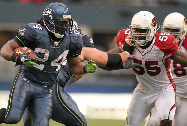 SEATTLE - OCTOBER 24:  Running back Marshawn Lynch #24 of the Seattle Seahawks rushes against Joey Porter #55 of the Arizona Cardinals at Qwest Field on October 24, 2010 in Seattle, Washington. (Photo by Otto Greule Jr/Getty Images)