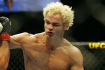 CHICAGO- OCTOBER 25: Josh Koscheck (R) punches Thiago Alves in a Welterweight bout  at UFC's Ultimate Fight Night at Allstate Arena on October 25, 2008 in Chicago, Illinois. (Photo by Tasos Katopodis/Getty Images)