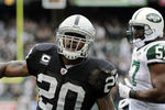 OAKLAND, CA - SEPTEMBER 25: Darren McFadden #20 of the Oakland Raiders tosses the ball away after scoring on a two yard touchdown run against the New York Jets in the first quarter during an NFL football game at the O.co Coliseum September 25, 2011 in Oakland, California.  (Photo by Thearon W. Henderson/Getty Images)