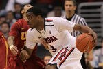 LOS ANGELES, CA - MARCH 11:  Kevin Parrom #3 of the Arizona Wildcats drives on Maurice Jones #10 of the USC Trojans in the semifinals of the 2011 Pacific Life Pac-10 Men's Basketball Tournament at Staples Center on March 11, 2011 in Los Angeles, California.  (Photo by Stephen Dunn/Getty Images)