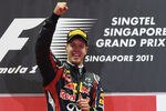 SINGAPORE - SEPTEMBER 25:  Sebastian Vettel of Germany and Red Bull Racing celebrates on the podium after winning the Singapore Formula One Grand Prix at the Marina Bay Street Circuit on September 25, 2011 in Singapore.  (Photo by Mark Thompson/Getty Images)