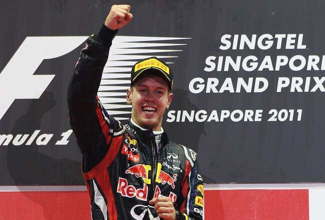SINGAPORE - SEPTEMBER 25:  Sebastian Vettel of Germany and Red Bull Racing celebrates on the podium after winning the Singapore Formula One Grand Prix at the Marina Bay Street Circuit on September 25, 2011 in Singapore.  (Photo by Mark Thompson/Getty Images)