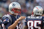 FOXBORO, MA -  SEPTEMBER 18:  Tom Brady #12 of the New England Patriots confers with  Chad Ochocinco #85 of the New England Patriots during a game with the San Diego Chargers at Gillette Stadium on September 18, 2011 in Foxboro, Massachusetts. (Photo by Jim Rogash/Getty Images)