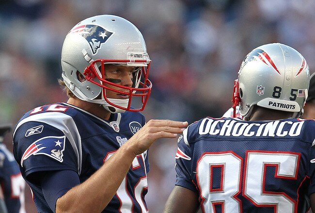 FOXBORO, MA -  SEPTEMBER 18:  Tom Brady #12 of the New England Patriots confers with  Chad Ochocinco #85 of the New England Patriots during a game with the San Diego Chargers at Gillette Stadium on September 18, 2011 in Foxboro, Massachusetts. (Photo by Jim Rogash/Getty Images)