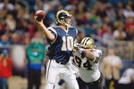 ST. LOUIS - NOVEMBER 15:  Quarterback Marc Bulger #10 of the St. Louis Rams looks to pass the ball against Charles Grant #94 of the New Orleans Saints at the Edward Jones Dome on November 15, 2009 in St. Louis, Missouri.  (Photo by Dilip Vishwanat/Getty Images)