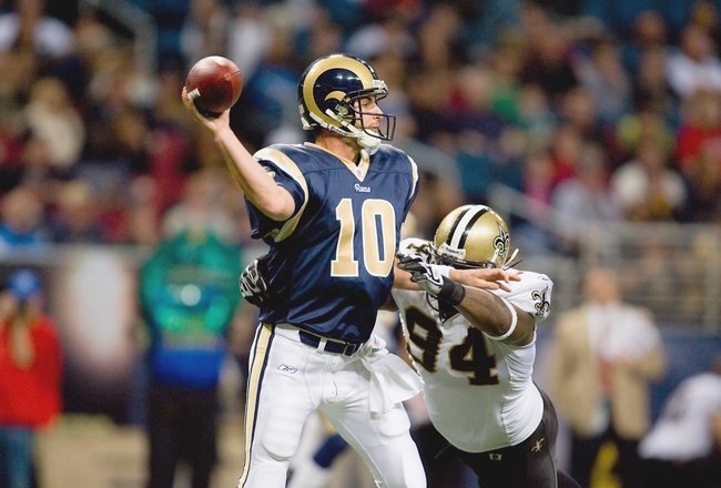 ST. LOUIS - NOVEMBER 15:  Quarterback Marc Bulger #10 of the St. Louis Rams looks to pass the ball against Charles Grant #94 of the New Orleans Saints at the Edward Jones Dome on November 15, 2009 in St. Louis, Missouri.  (Photo by Dilip Vishwanat/Getty Images)