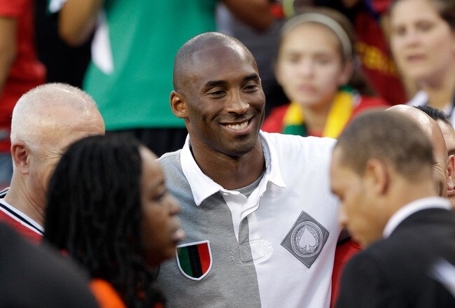 LANDOVER, MD - JULY 30:  NBA basketball player Kobe Bryant poses with fans during a half time event at the Manchester United and Barcelona friendly match at FedExField on July 30, 2011 in Landover, Maryland.  (Photo by Rob Carr/Getty Images)