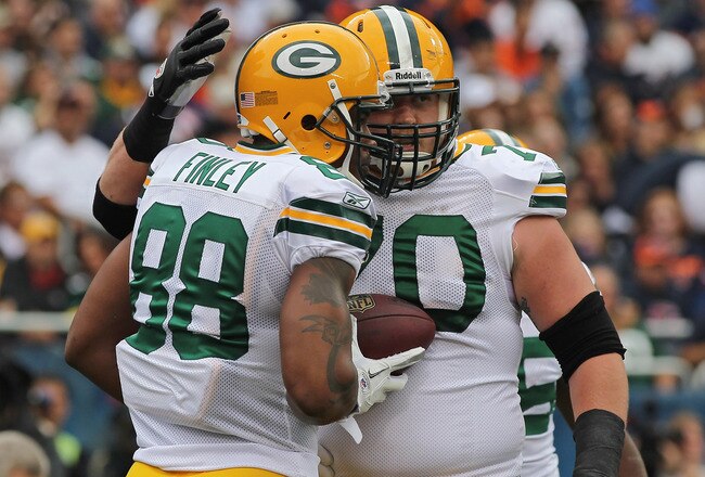 CHICAGO, IL - SEPTEMBER 25: Jermichael Finley #88 of the Green Bay Packers is congratulated by teammate Chad Clifton #70 after catching a touchdown pass against the Chicago Bears at Soldier Field on September 25, 2011 in Chicago, Illinois. The Packers defeated the Bears 27-17.  (Photo by Jonathan Daniel/Getty Images)