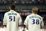 PHOENIX, AZ - SEPTEMBER 10:  Randy Johnson and Curt Schilling, former members of the 2001 Arizona Diamondbacks World Series team stand attended for the National Anthem before the Major League Baseball game against the San Diego Padres at Chase Field on September 10, 2011 in Phoenix, Arizona. The Diamondbacks are celebrating the 10th anniversary of their World Series title.  (Photo by Christian Petersen/Getty Images)