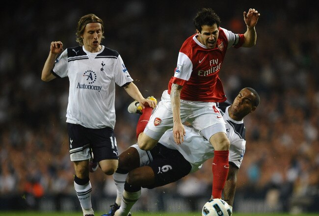 LONDON, ENGLAND - APRIL 20:  Cesc Fabregas of Arsenal is tackled by Tom Huddlestone of Spurs during the Barclays Premier League match between Tottenham Hotspur and Arsenal at White Hart Lane on April 20, 2011 in London, England.  (Photo by Laurence Griffiths/Getty Images)