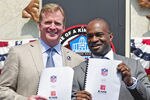 CANTON, OH - AUGUST 5:  NFL Commissioner Roger Goodell (L) and NFLPA Executive Director Demaurice Smith hold up the NFL's new 10-year Collective Bargaining Agreement at the Pro Football Hall of Fame August 5, 2011 in Canton, Ohio.   (Photo by Jason Miller/Getty Images)
