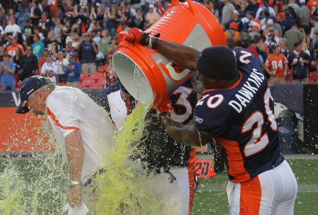 DENVER, CO - SEPTEMBER 18:  Head coach John Fox of the Denver Broncos is doused with Gatorade by Brian Dawkins #20 of the Denver Broncos after their 24-22 victory over the Cincinnati Bengals at Invesco Field at Mile High on September 18, 2011 in Denver, Colorado.  (Photo by Doug Pensinger/Getty Images)