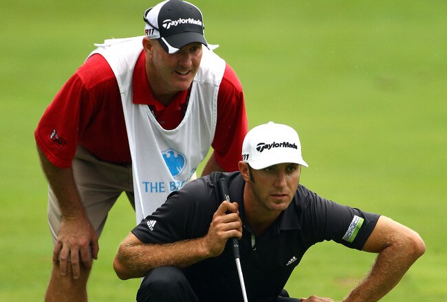 EDISON, NJ - AUGUST 27:  Dustin Johnson (R) and caddie Joe Lacava line up a putt on the 16th hole green during the third and final round of The Barclays at Plainfield Country Club on August 27, 2011 in Edison, New Jersey. The tournament was cut down from a 72 hole competition to 54 holes due to the the impending arrival of Hurricane Irene.  (Photo by Scott Halleran/Getty Images)