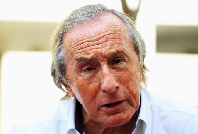 SINGAPORE - SEPTEMBER 23:  Sir Jackie Stewart is interviewed in the paddock before practice for the Singapore Formula One Grand Prix at the Marina Bay Street Circuit on September 23, 2011 in Singapore.  (Photo by Vladimir Rys/Getty Images)