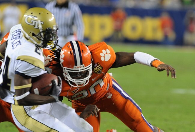 TAMPA, FL - NOVEMBER 28: Linebacker Brandon Maye #20 of the Clemson Tigers tackles running back Embry Peeples #24 of the Georgia Tech Yellow Jackets  in the 2009 ACC Football Championship Game December 5, 2009 at Raymond James Stadium in Tampa, Florida.  (Photo by Al Messerschmidt/Getty Images)