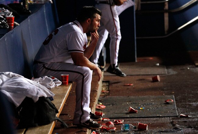 ATLANTA, GA - SEPTEMBER 26:  Dan Uggla #26 of the Atlanta Braves sits in the dugout after their 4-2 loss to the Philadelphia Phillies at Turner Field on September 26, 2011 in Atlanta, Georgia.  (Photo by Kevin C. Cox/Getty Images)