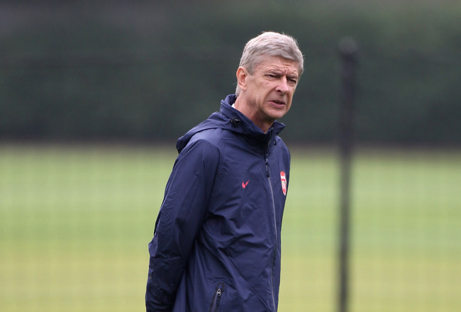 ST ALBANS, ENGLAND - SEPTEMBER 27:  Arsene Wenger of Arsenal looks on during a training session ahead of their UEFA Champions League Group match against Olympiacos at London Colney on September 27, 2011 in St Albans, England.  (Photo by Clive Rose/Getty Images)