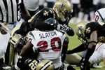 HOUSTON - AUGUST 22:  Running back Steve Slaton #20 of the Houston Texans is tackled by Chris Reis #39, Tracy Porter #22 and Roman Harper #41 of the New Orleans Saints on August 22, 2009 in Houston, Texas.  (Photo by Bob Levey/Getty Images)