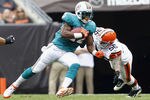 CLEVELAND, OH - SEPTEMBER 25:  Running back Reggie Bush #22 of the Miami Dolphins runs by linebacker Kaluka Maiava #56 of the Cleveland Browns at Cleveland Browns Stadium on September 25, 2011 in Cleveland, Ohio.  (Photo by Matt Sullivan/Getty Images)