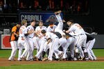 BALTIMORE, MD - SEPTEMBER 28:  Robert Andino #11 of the Baltimore Orioles is mobbed by teammates after driving in the game winning run in the ninth inning against the Boston Red Sox at Oriole Park at Camden Yards on September 28, 2011 in Baltimore, Maryland. Baltimore won the game 4-3.  (Photo by Greg Fiume/Getty Images)