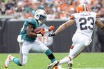 CLEVELAND, OH - SEPTEMBER 25: Running back Reggie Bush #22 of the Miami Dolphins tries to avoid defensive back Joe Haden #23 of the Cleveland Browns during the first quarter at Cleveland Browns Stadium on September 25, 2011 in Cleveland, Ohio. (Photo by Jason Miller/Getty Images)