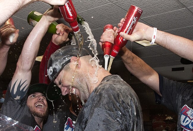 HOUSTON - SEPTEMBER 28:  Pitcher Chris Carpenter of the St. Louis Cardinals is showered with beer as they celebrate winning the National League wild card at Minute Maid Park on September 28, 2011 in Houston, Texas.  (Photo by Bob Levey/Getty Images)
